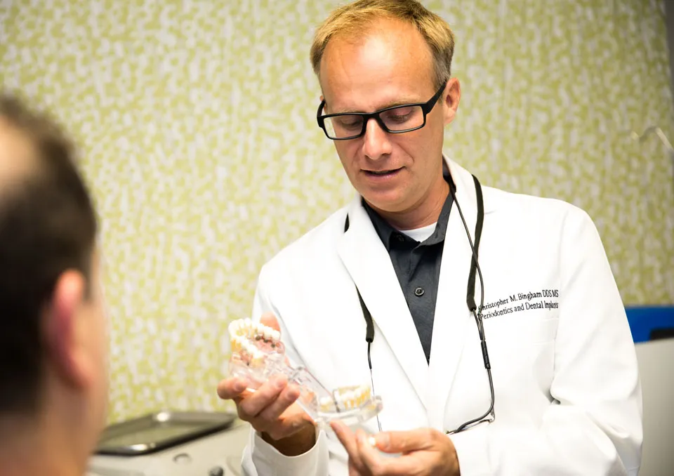 dr bingham discussing dental implant procedure with patient 1